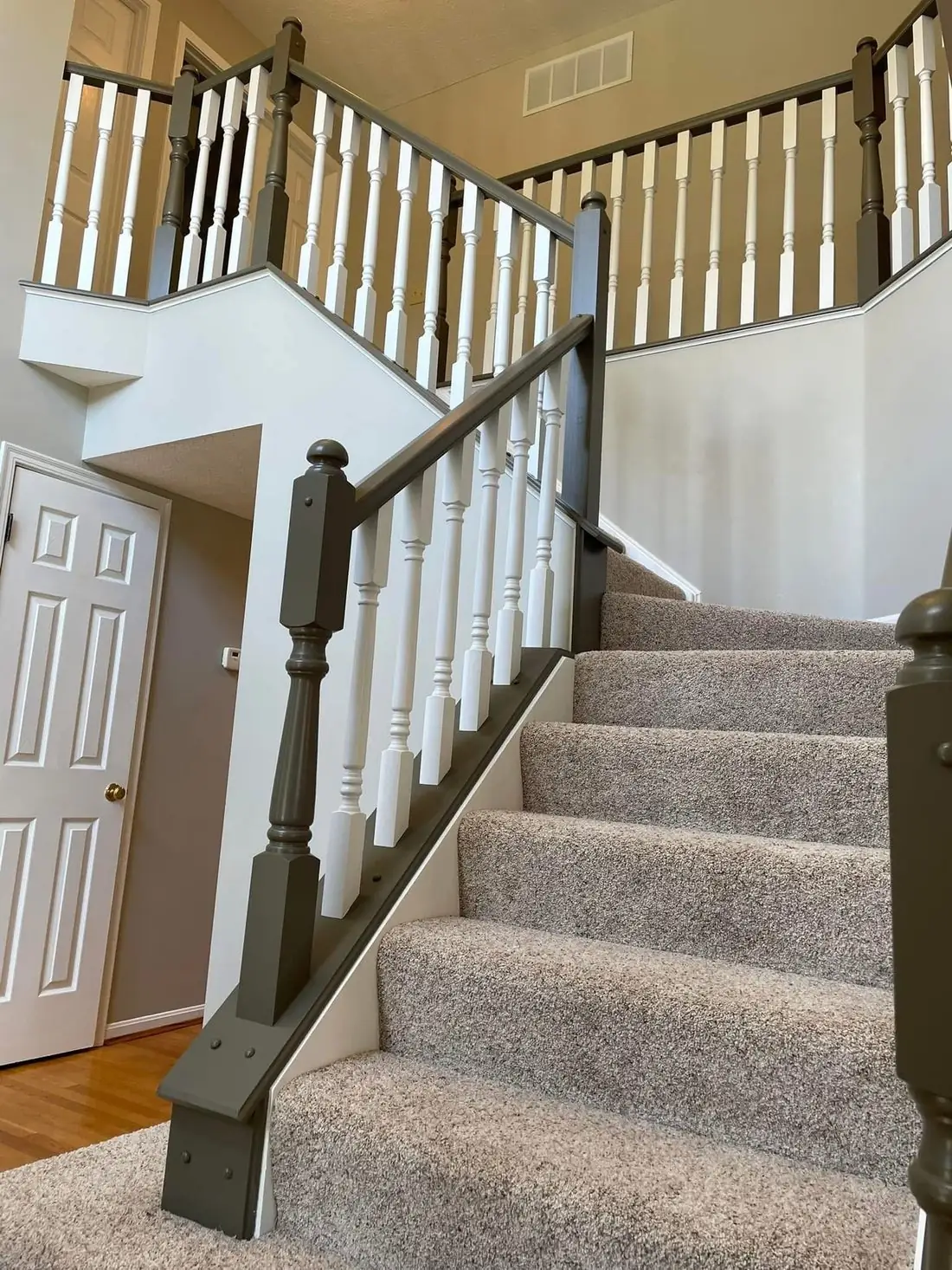 Painted gray staircase railing with white spindles &mdash; interior painting Northern Kentucky