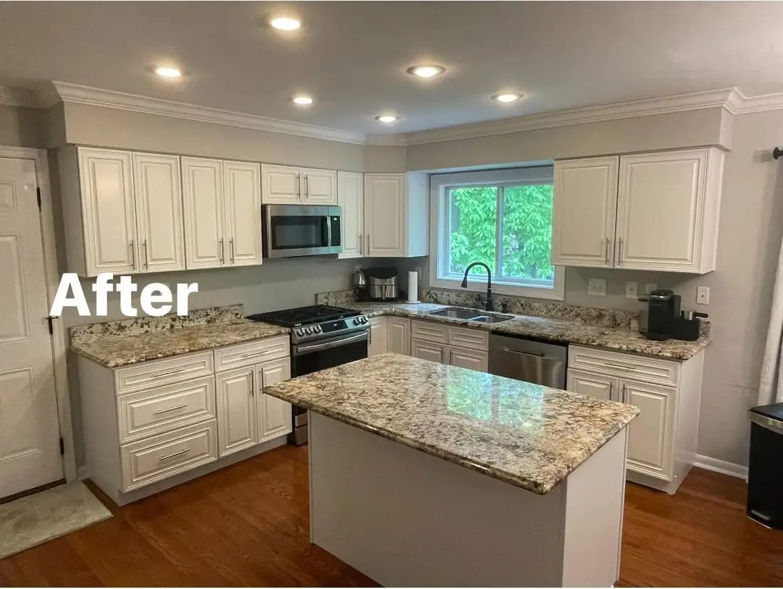 Same kitchen after F&C cabinet refinishing &mdash; bright white painted cabinets