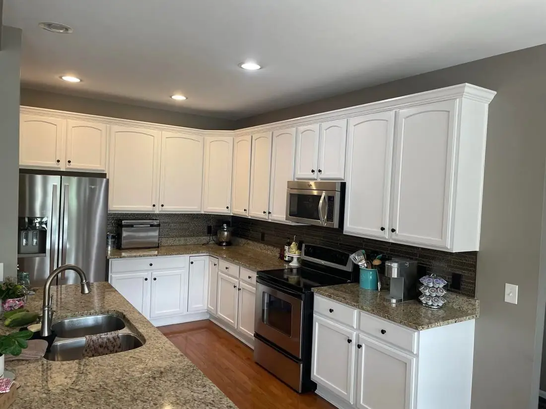 White painted kitchen cabinets with brown granite countertops &mdash; cabinet refinishing in NKY