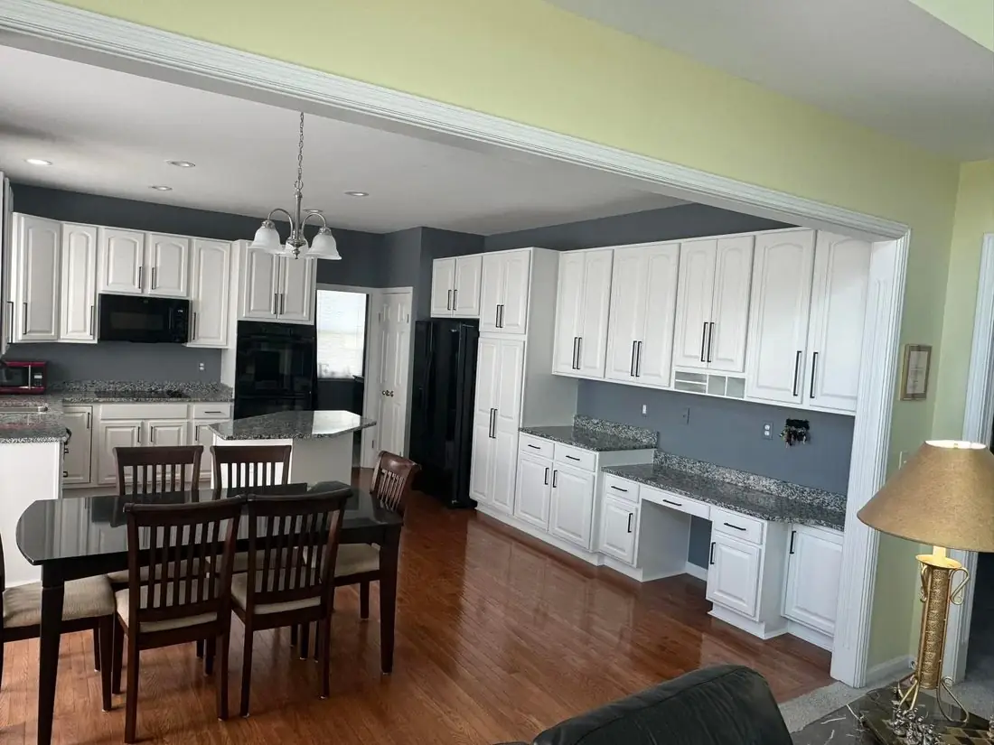 Bright white kitchen cabinets with island after F&C refinishing in Northern Kentucky